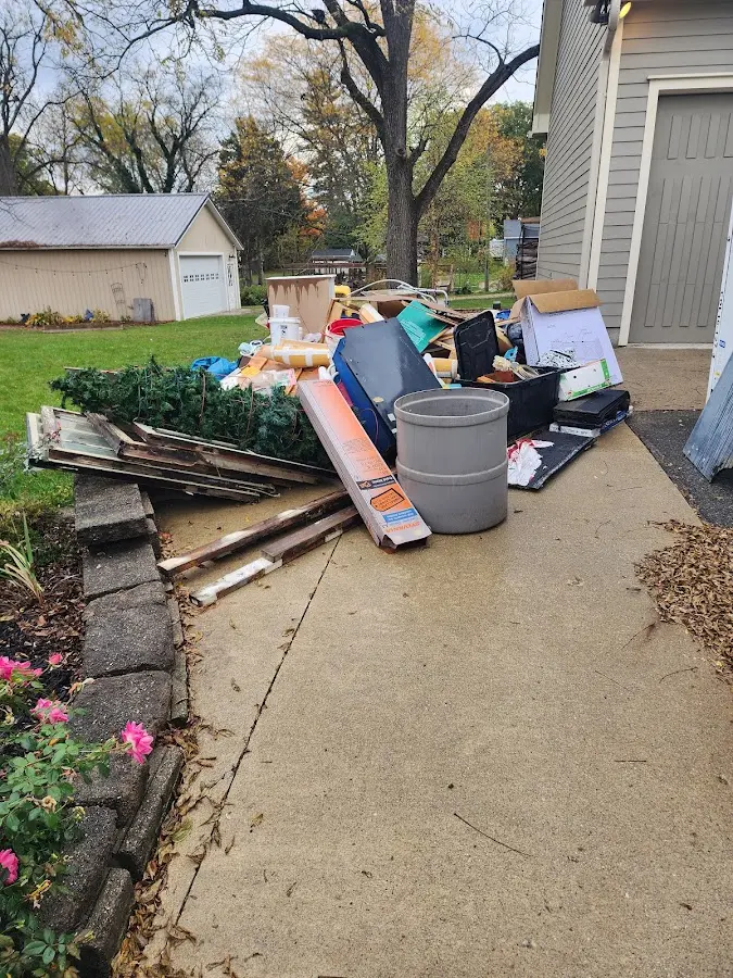 Dumpster being loaded with debris for Roofing Dumpster Rental in North Elba